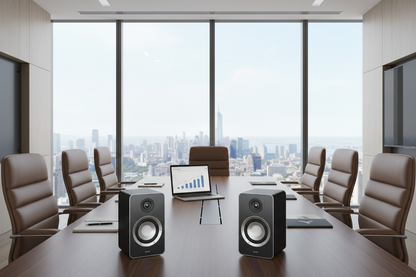 show a picture of desk top speakers in a office meeting
